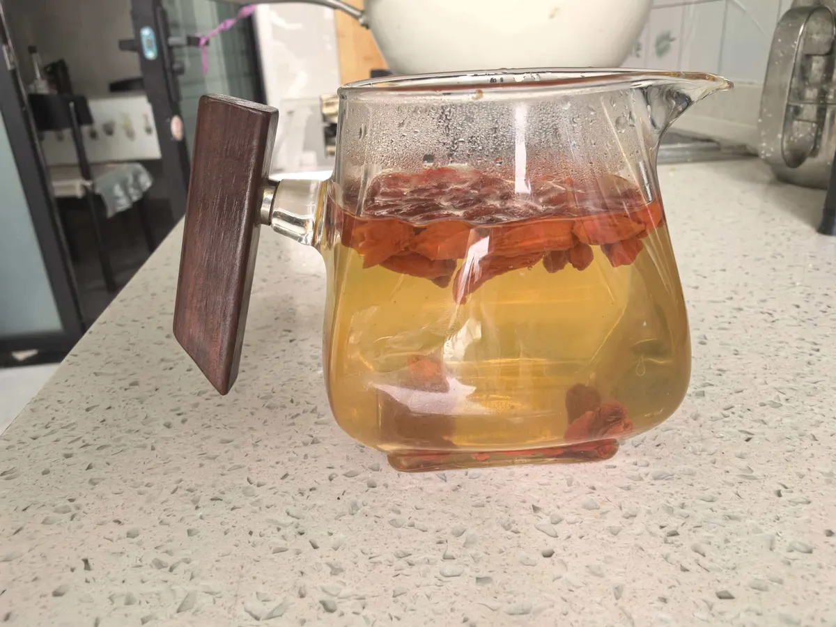Goji berry herbal tea in glass pitcher — a traditional Chinese wellness beverage